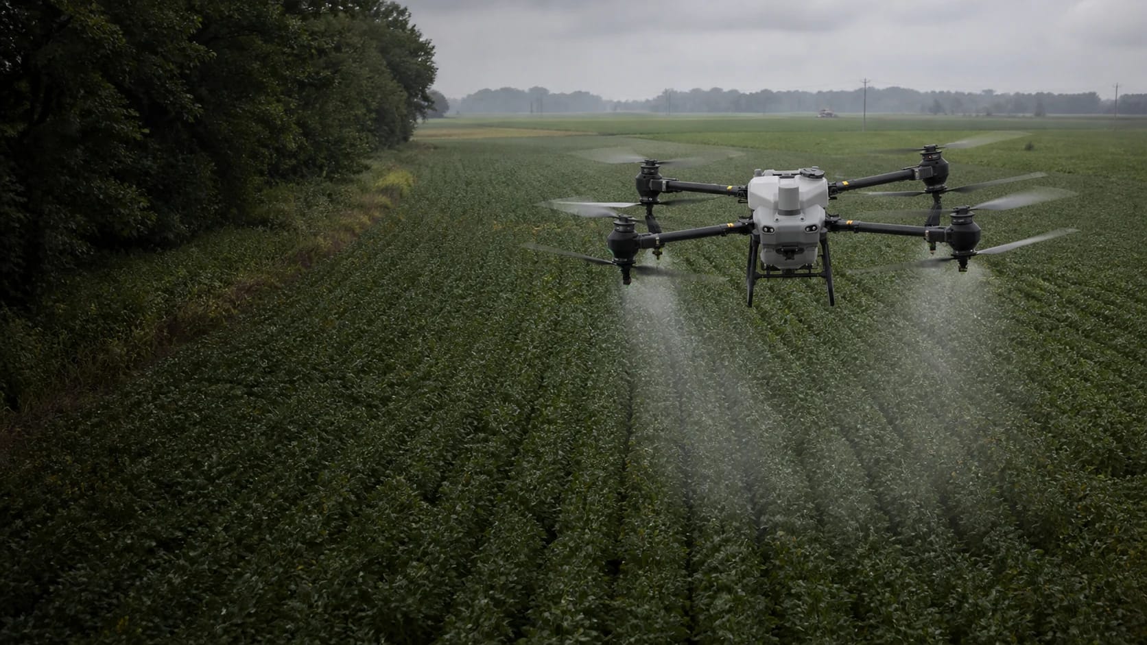 DJI AGRAS T50 applying a fine spray over soybean rows