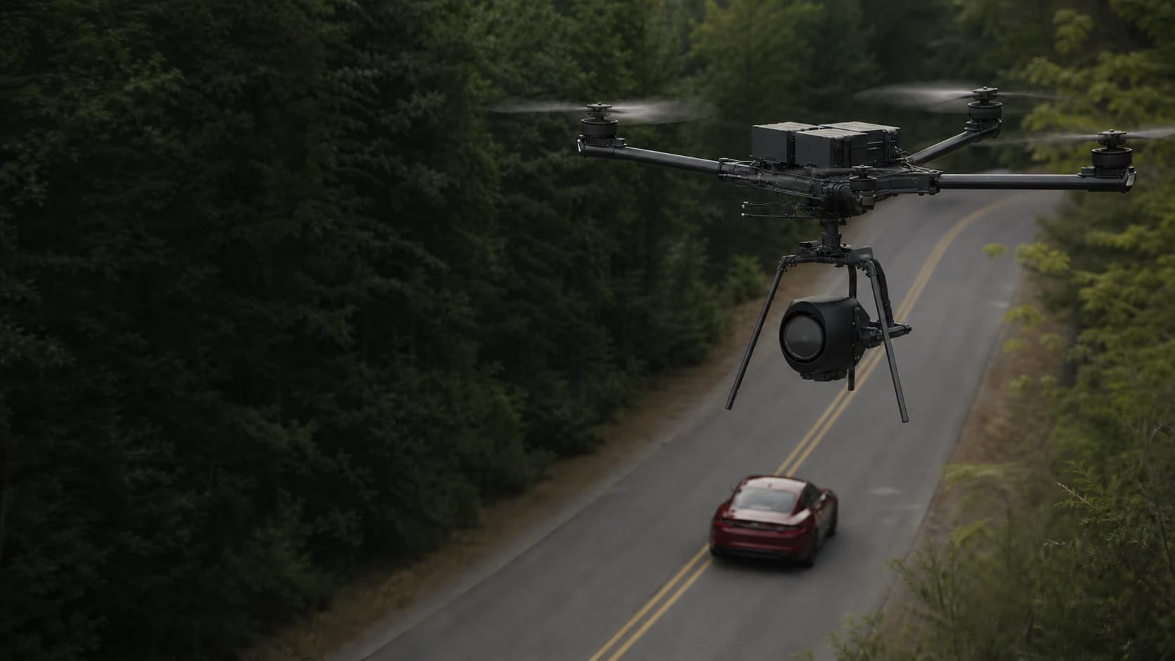 Freefly Alta X carrying a cinema camera above a closed forest road during an automotive shoot