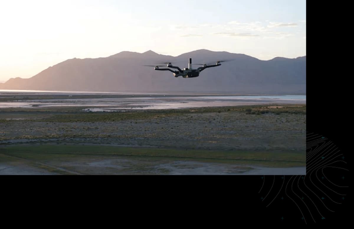 Teal Black Widow aircraft flying over Utah terrain