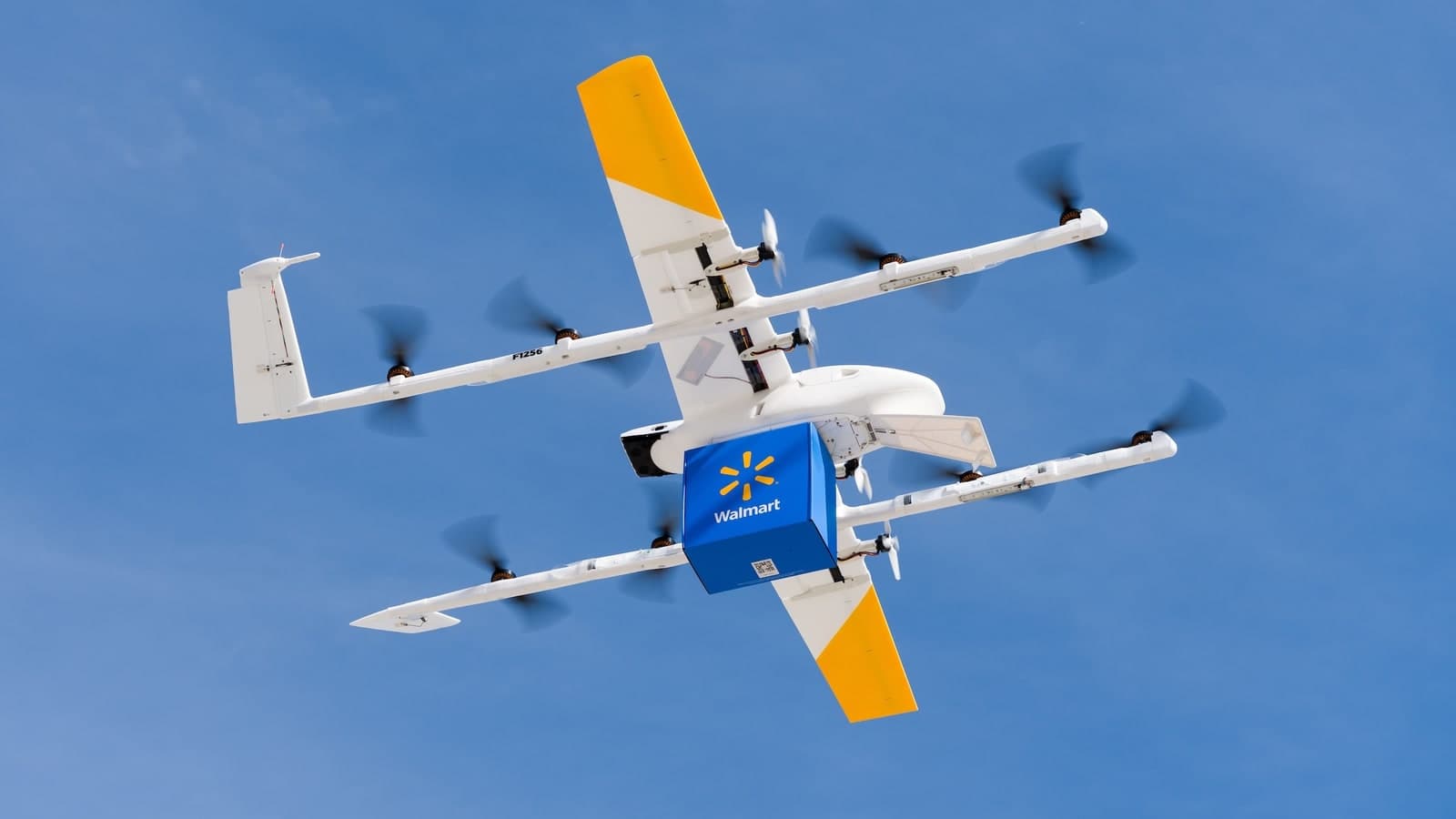 Wing delivery aircraft carrying a Walmart package in flight, representing the service proposed for Colorado stores