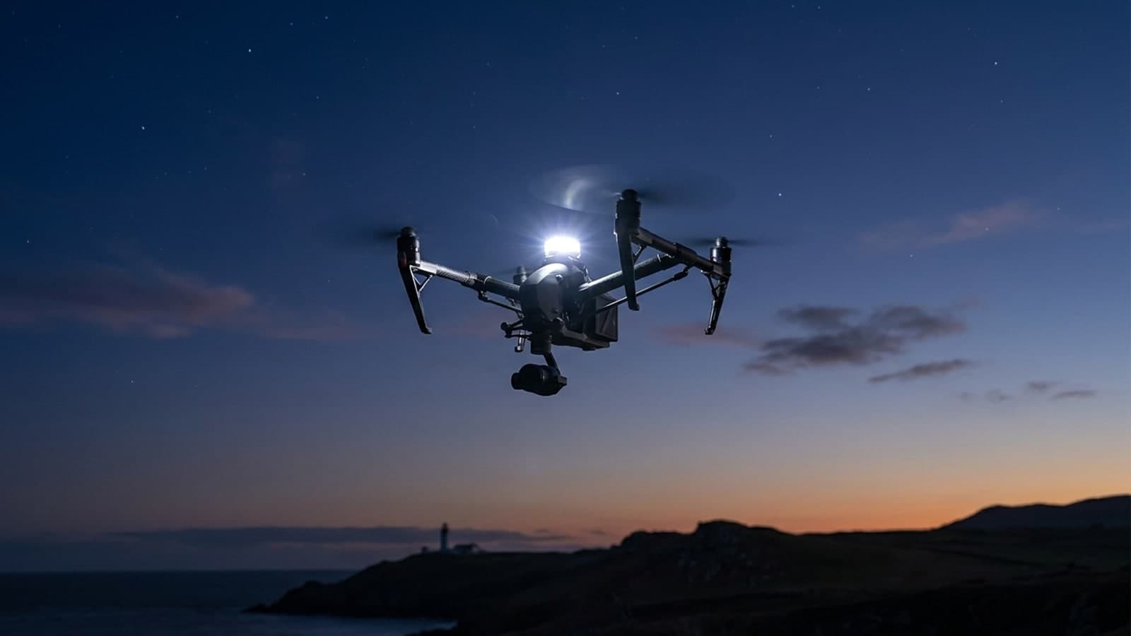 Illuminated drone flying over a city at night, representing an operation subject to FAA enforcement