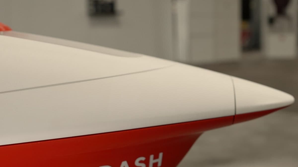Close view of the white and red nose of DoorDash Air's in-house delivery aircraft