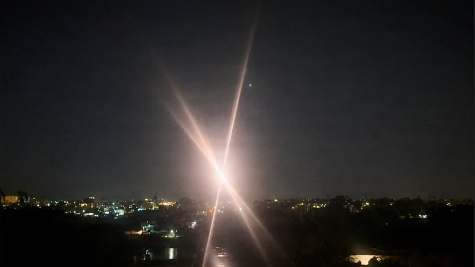 Bright beam from the Army Multipurpose High Energy Laser during a nighttime counter-drone engagement