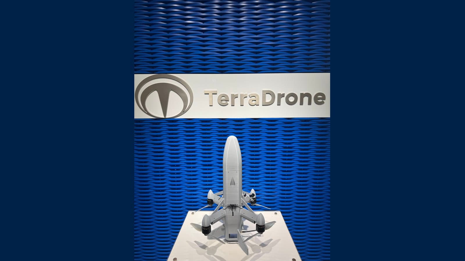 Terra B1 interceptor drone displayed vertically beneath the Terra Drone name on a blue wall